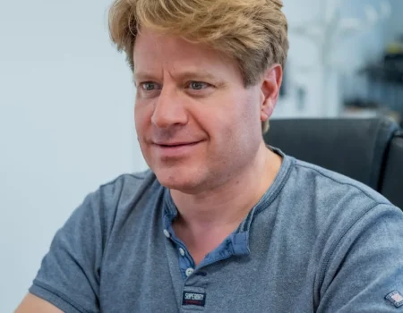 image of a man smiling looking at a computer